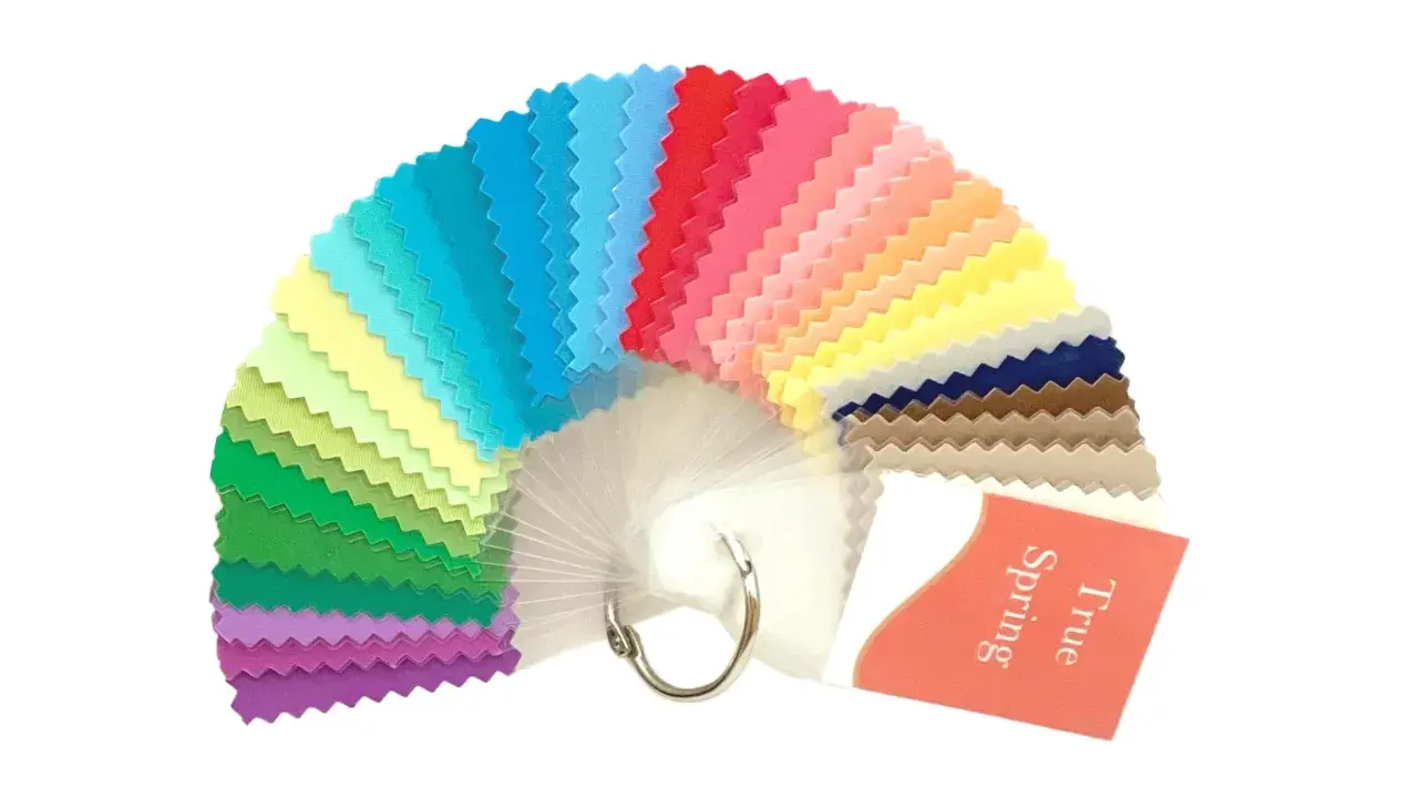 A fan of fabric swatches in various bright colors, with a tag reading "True Spring".